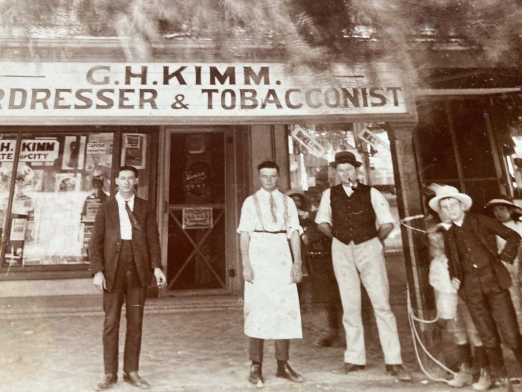 People standing in front of shop.